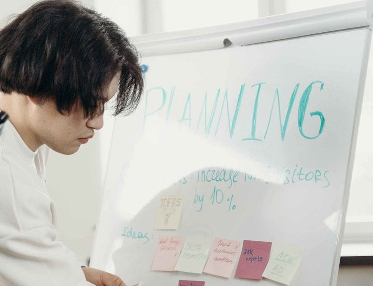 worker writing on board