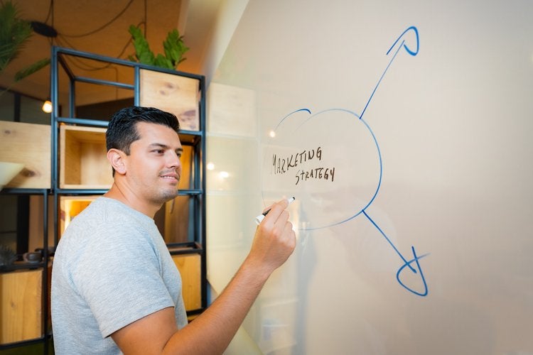 worker writing on board